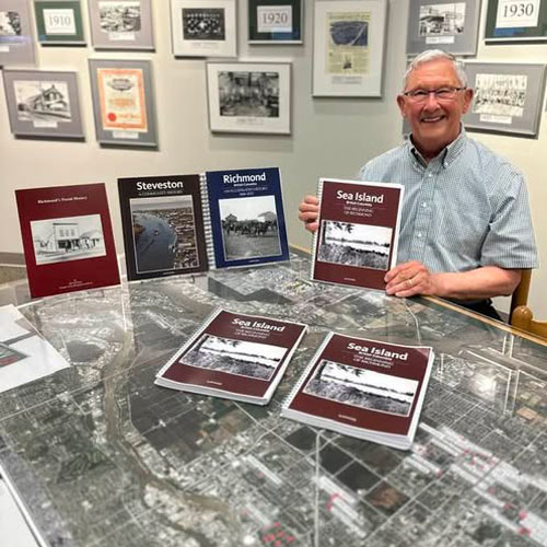 Bill McNulty holding book Sea Island the Beginning of Richmond