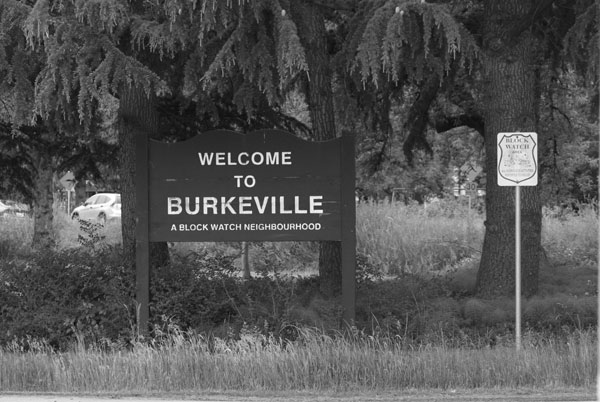 street sign Welcome to Burkeville and trees